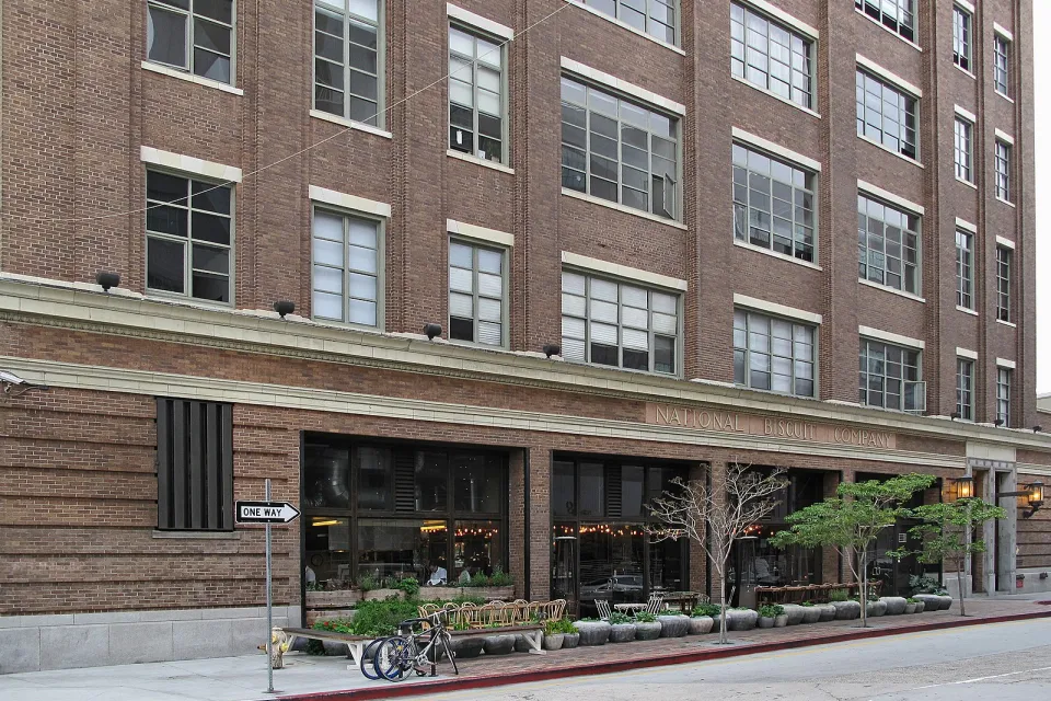 View of the National Biscuit Company Building, 1850 Industrial Street, Los Angeles from the corner of Mateo Street. It has been renovated into lofts, with a restaurant on the ground floor.